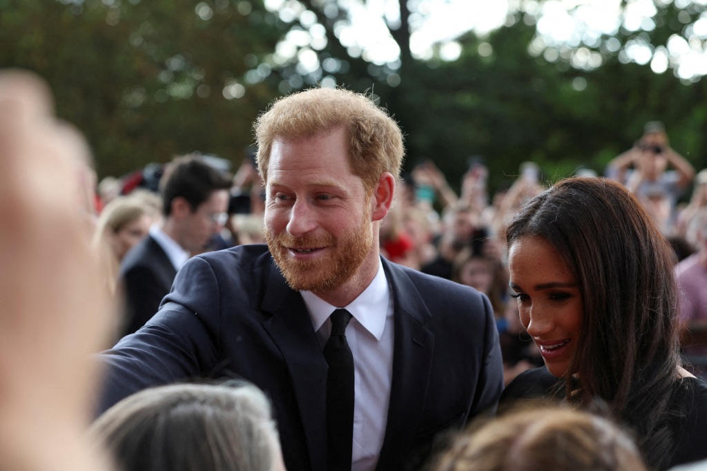 Britain's Prince Harry and Meghan, the Duchess of Sussex, greet people as they walk outside Windsor Castle, following the passing of Britain's Queen Elizabeth, in Windsor, Britain, September 10, 2022. 