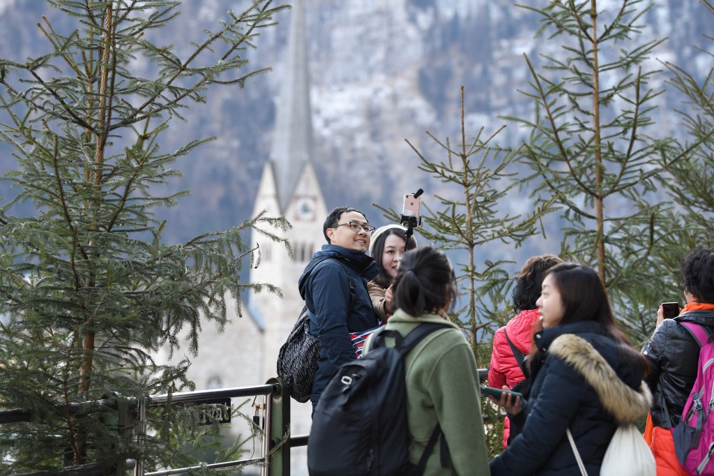 Tourists take photos in the town center