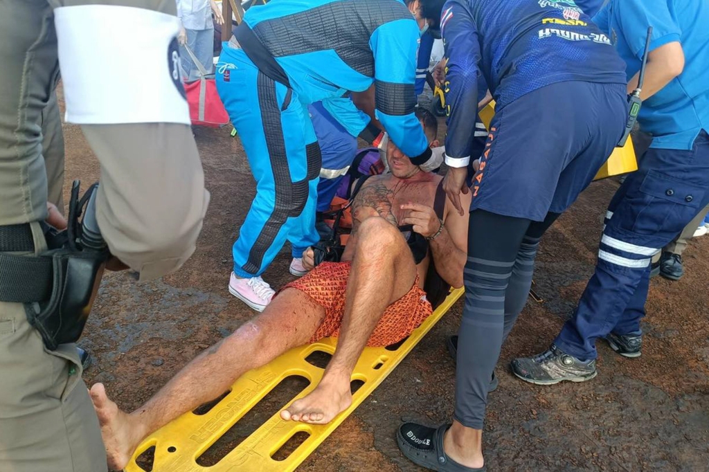 An injured man on a stretcher is pictured