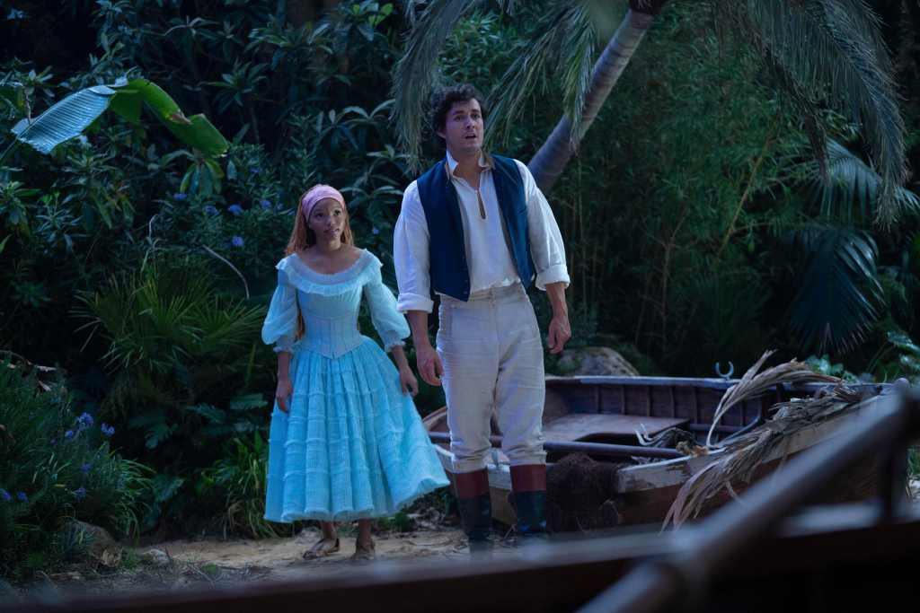 Prince Eric (Jonah Hauer-King) takes Ariel (Bailey) on a tour of his kingdom. 