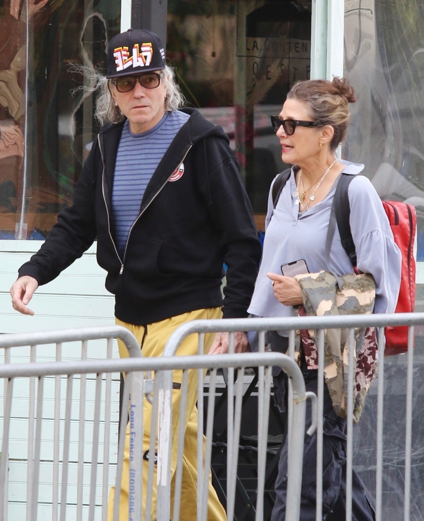 On Friday, the star was spotted for the second time in as many days, donning the same cap and glasses as he walked hand-in-hand with longtime wife, Rebecca Miller, 60. 