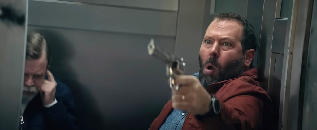 Kreischer, holding a gun, morphs into an action hero in "The Machine."