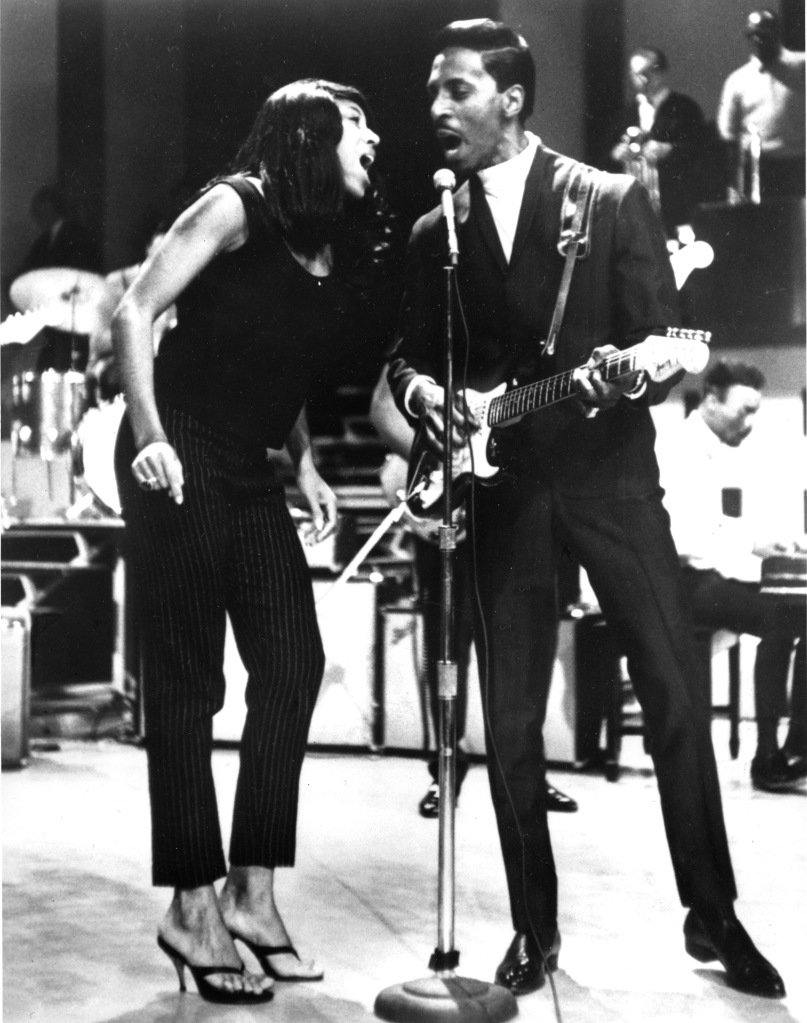 Tina and Ike Turner singing in black and white image