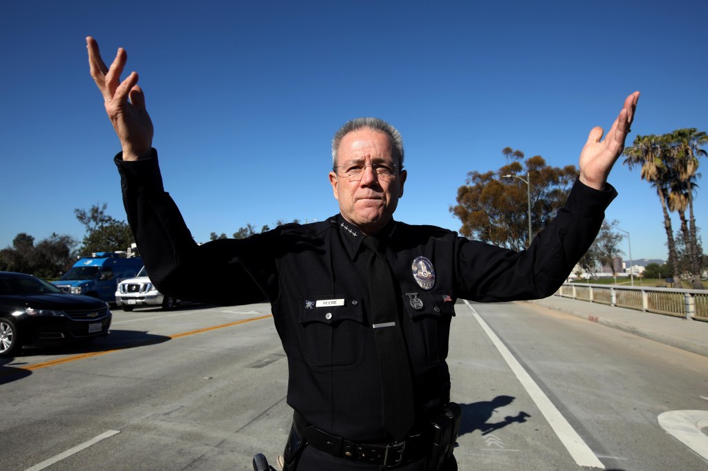 L.A.P.D. Chief Michael Moore gestures to the crowd before a walk across the Sixth Street Viaduct 