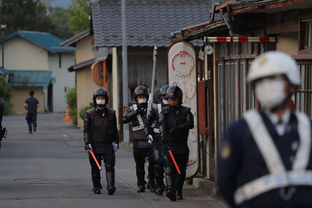 Police officers are seen near the scene of the standoff with Aoki