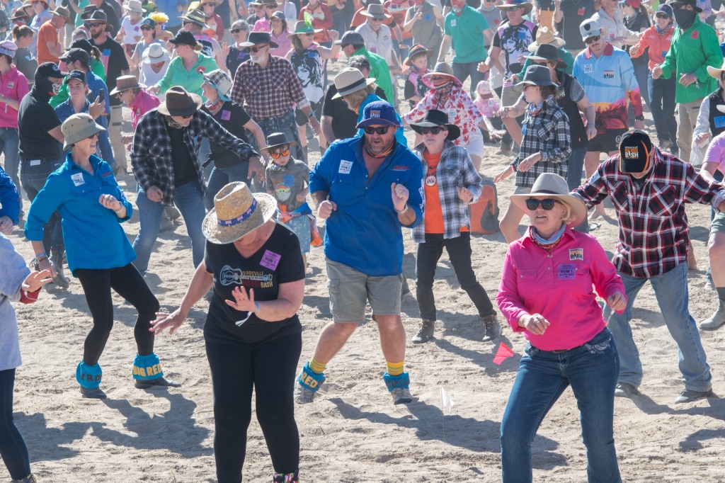 Dancers doing the Natbush on beach in Australia