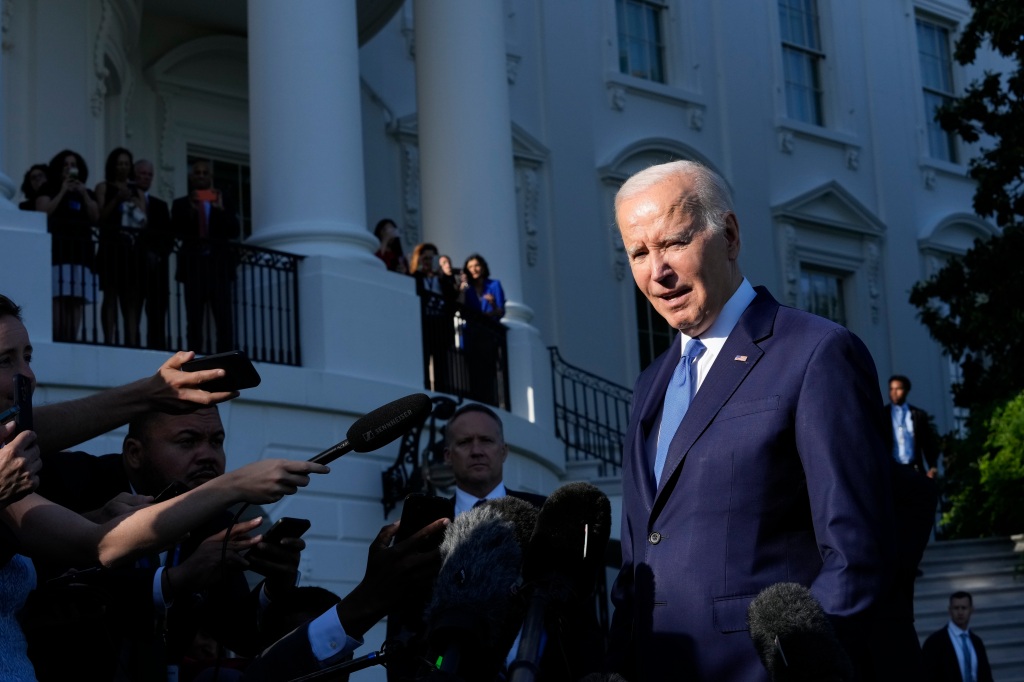 Biden is pictured outside the White House
