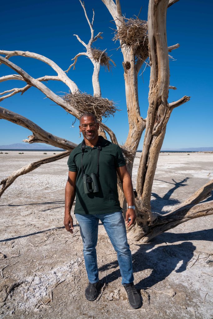 christian is pictured by birds' nests by the edge of California's Salton Sea.  