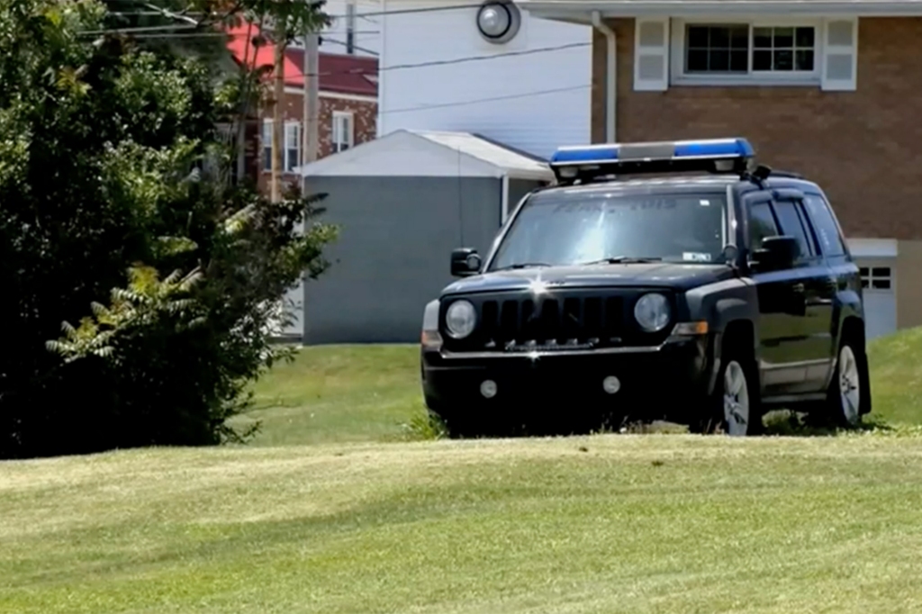 A police vehicle parked on the lawn outside a home