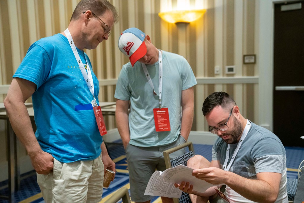 Pronouncer Jacques Bailly (from left), Backup Associate Pronouncer Christian Axelgard and Kevin Moch convene during a meeting of the word panel. 