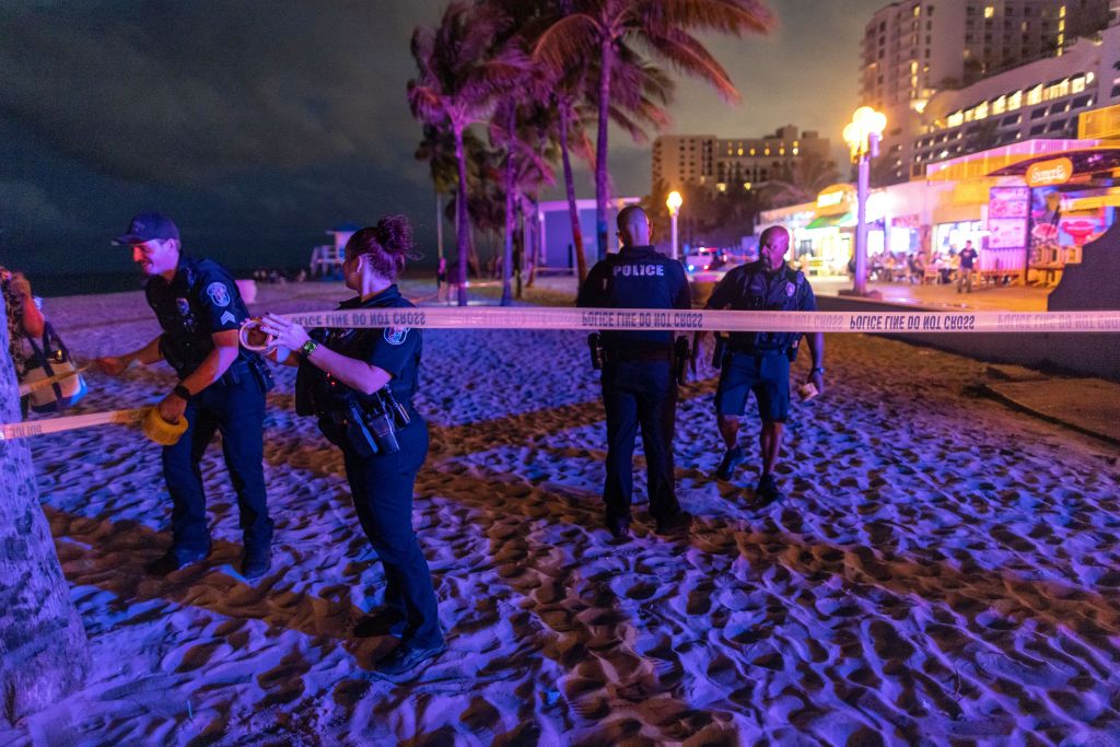 Police officer investigating the scene of the mass shooting at the beach.