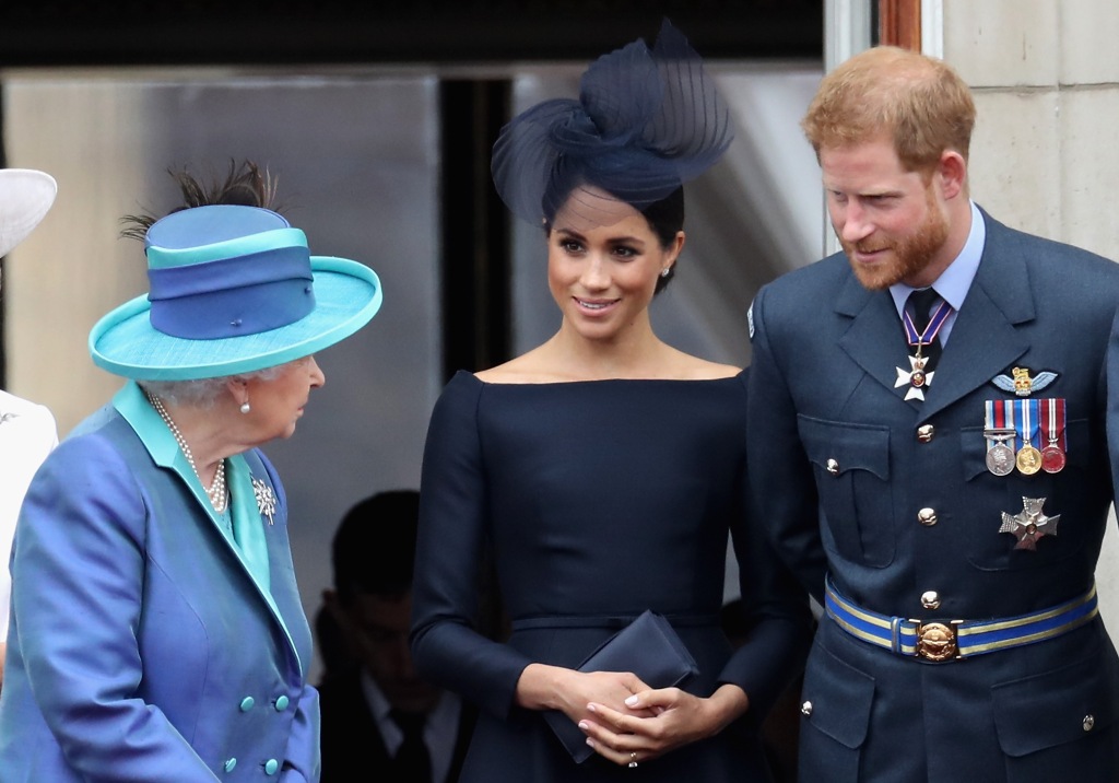 Prince Harry and Meghan Markle share a laugh with the late Queen Elizabeth on July 10, 2018.