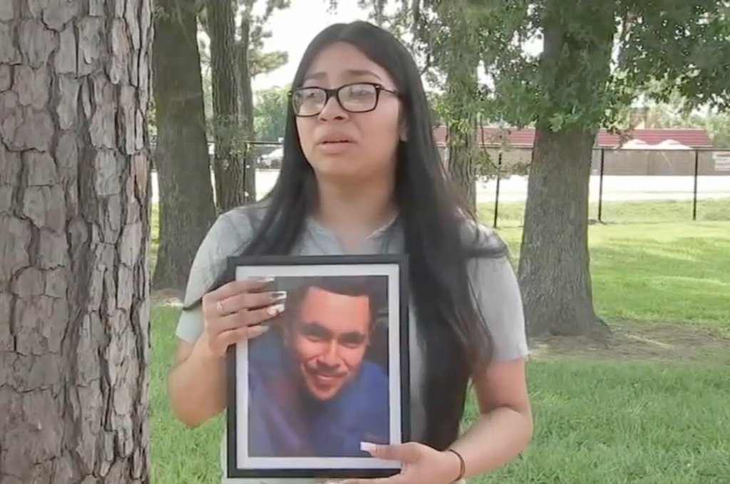 Destiny Tobias holds a picture of her father.