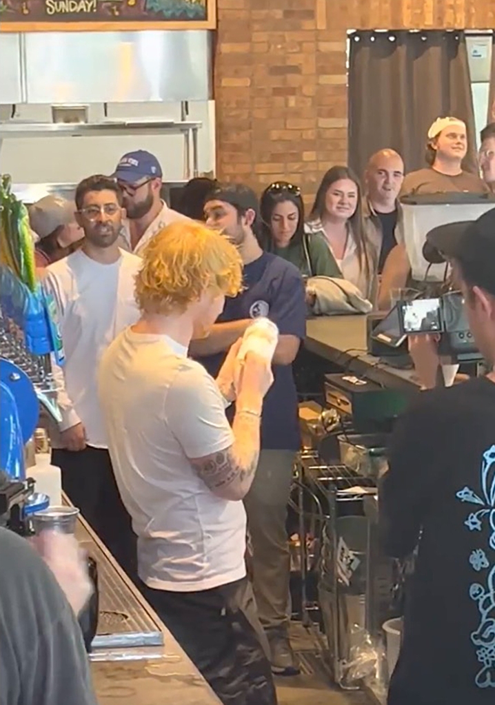 Ed Sheeran signing a beer can