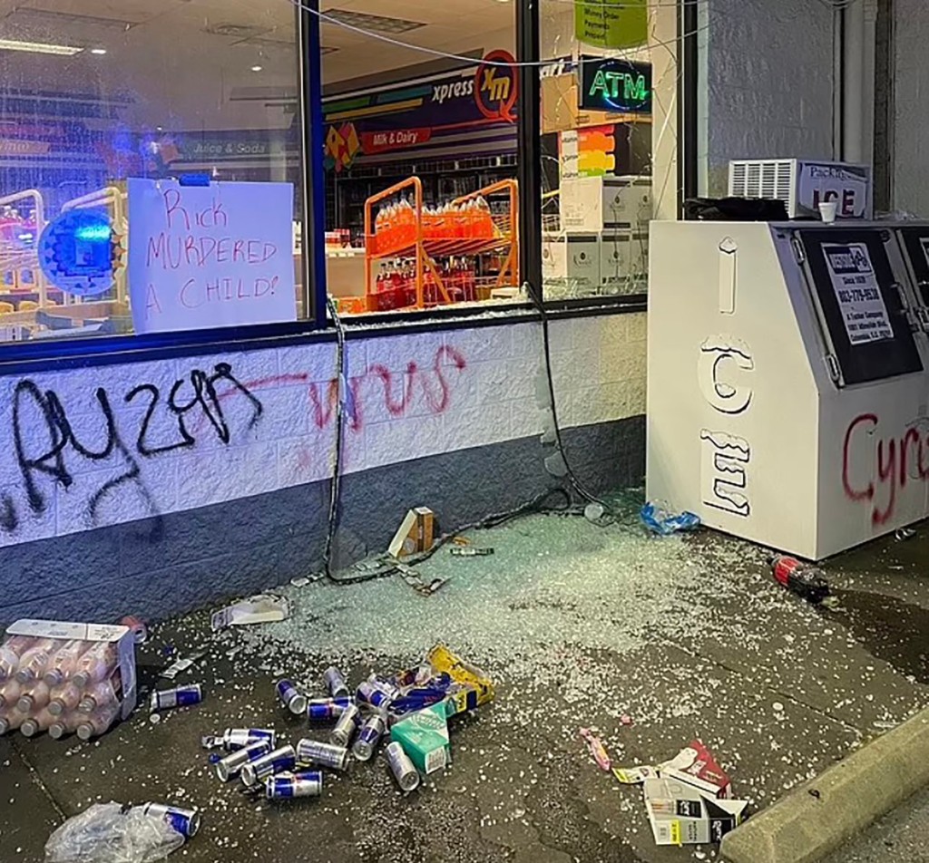 Graffiti and debris are seen at Chow's store after being ransacked by a large group of people. 