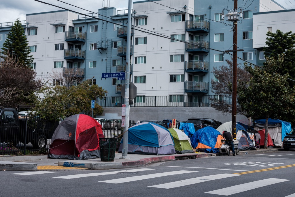 Many homeless people living in tents on the sidewalk are seen on the junction of Las Palmas Ave and Selma, Hollywood, Los Angeles.