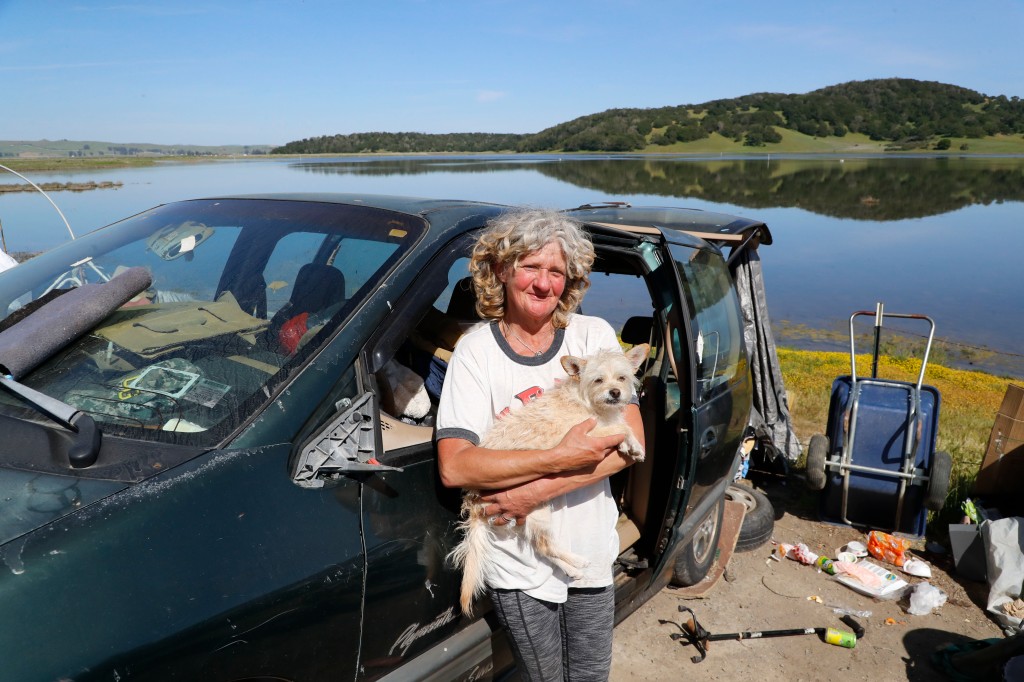 Shelly G., 53, shown with her dog Bailey of Petaluma, California has lived at the RV encampment along Binford Road outside Novato, California for 3-weeks. 