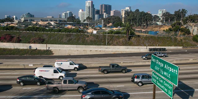 San Diego freeway with city skyline in background