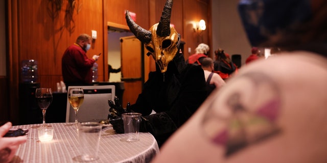 Demon-headed attendee at SatanCon