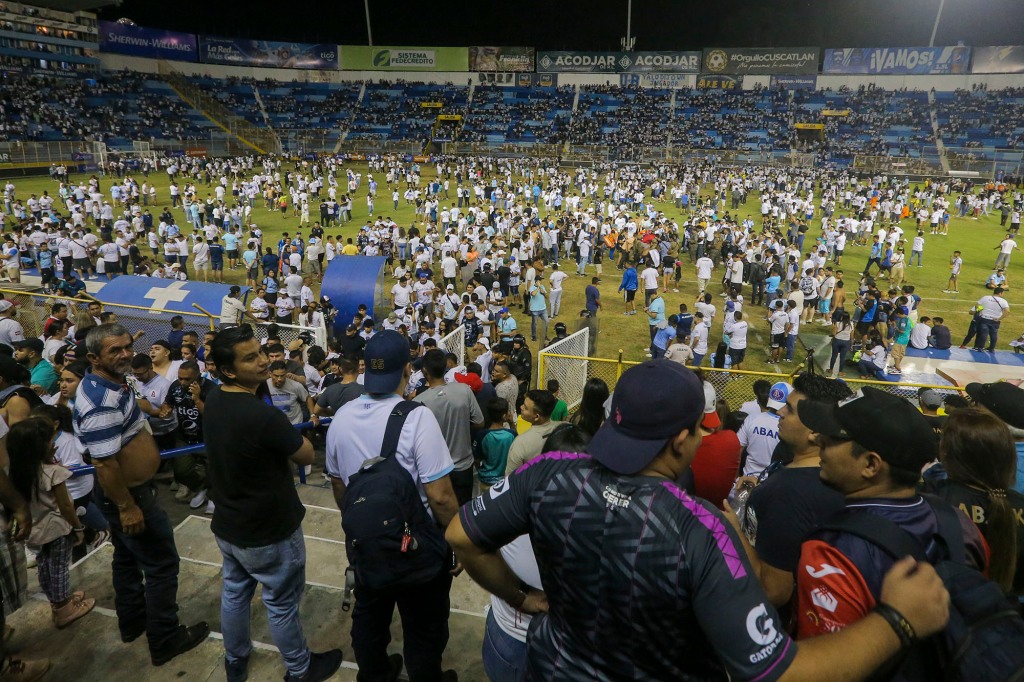 Fans are seen rushing onto the field of Cuscatlan stadium in San Salvador, El Salvador, on May 20, 2023. 
