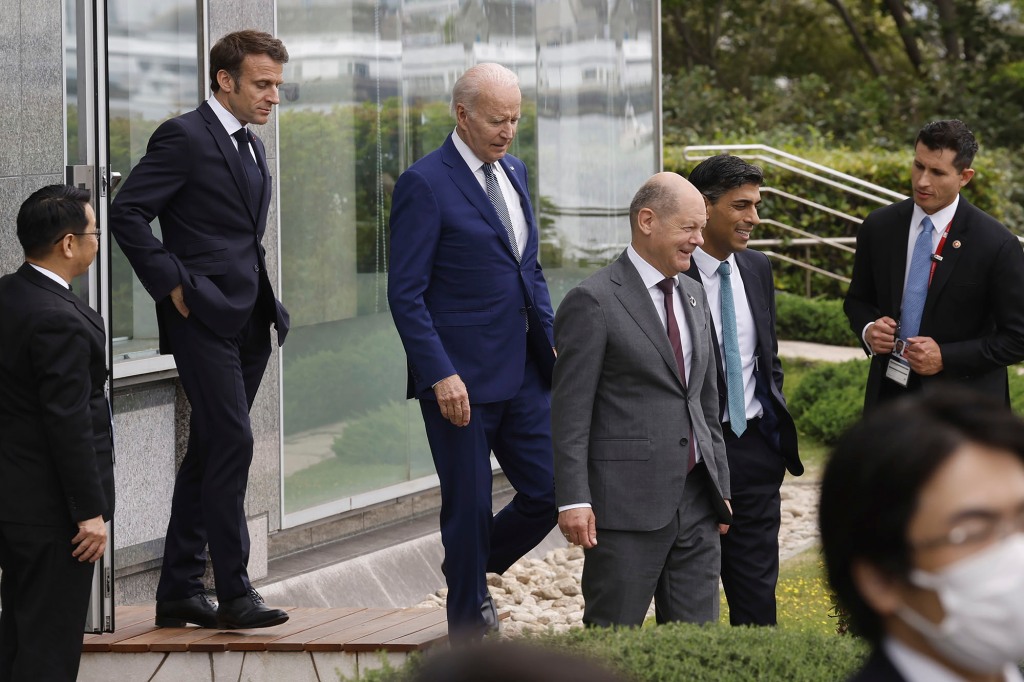 President Joe Biden, center left, France's President Emmanuel Macron, second left, German Chancellor Olaf Scholz, center right, and British Prime Minister Rishi Sunak, second right, walk to participate in a family photo with G7 leaders before their working lunch meeting. 