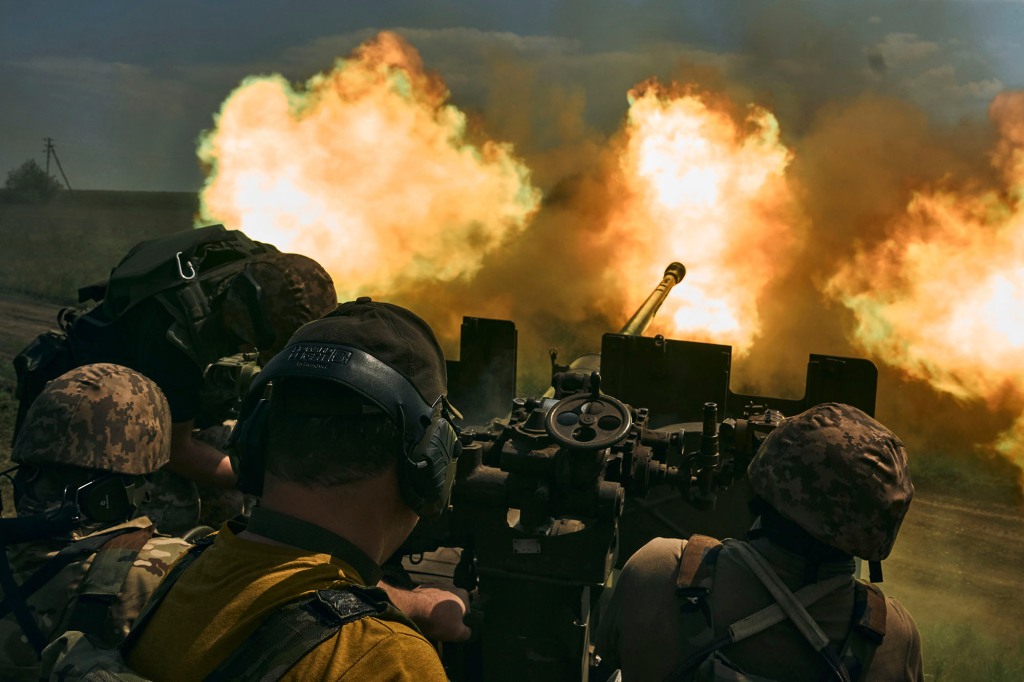 Ukrainian soldiers fire a cannon near Bakhmut, an eastern city where fierce battles against Russian forces have been taking place, in the Donetsk region, Ukraine, May 15, 2023.