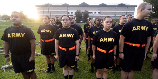 Soldiers outdoors in black Army PT uniforms