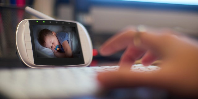 parent watches child on baby monitor 