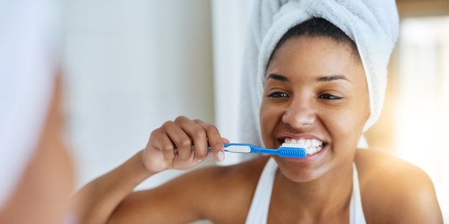 Woman brushing teeth