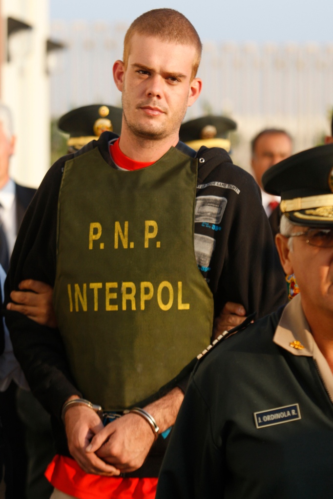 Joran van der Sloot is escorted by police officers outside a Peruvian police station, near the border with Chile in Tacna, Peru.