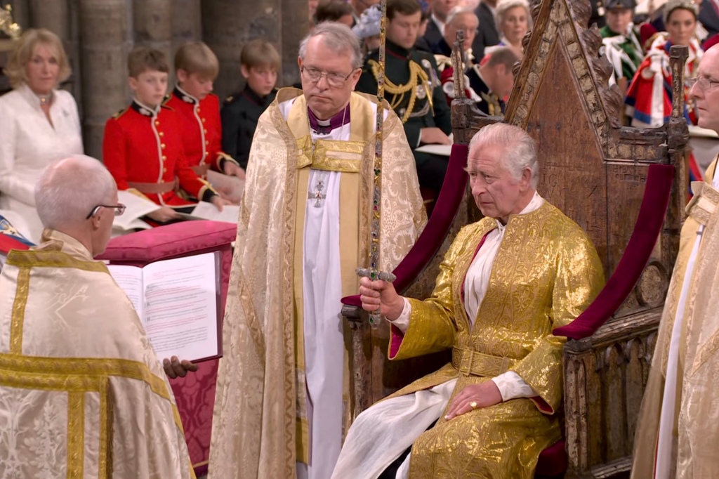 Charles wields a gemstone-encrusted sword at his enthronement on Saturday. 