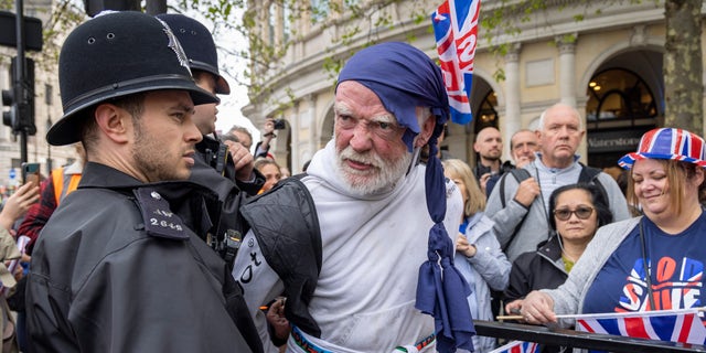 Police arresting man wearing a bandana