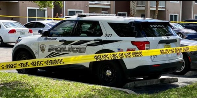 Police cruiser in front of a yellow caution tape.