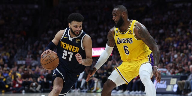 Jamal Murray #27 of the Denver Nuggets drives against LeBron James #6