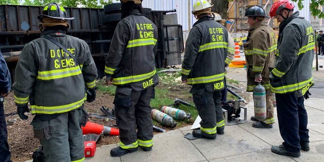 DC emergency workers near overturned truck