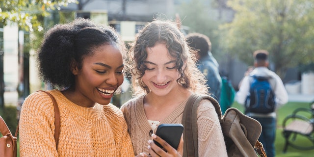 Girls smiling on phone