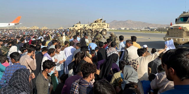 U.S soldiers stand guard along a perimeter at the international airport in Kabul, Afghanistan, Monday, Aug. 16, 2021. On Monday, the U.S. military and officials focus was on Kabul’s airport, where thousands of Afghans trapped by the sudden Taliban takeover rushed the tarmac and clung to U.S. military planes deployed to fly out staffers of the U.S. Embassy, which shut down Sunday, and others.