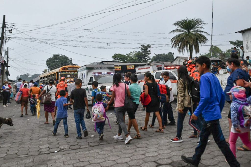 People are spotted during evacuations following a government order in response to Fuego volcano.