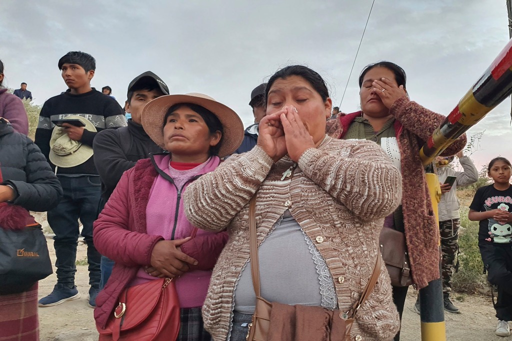 Relatives of trapped miners wait outside the SERMIGOLD mine in Arequipa, Peru, Sunday, May 7, 2023. 