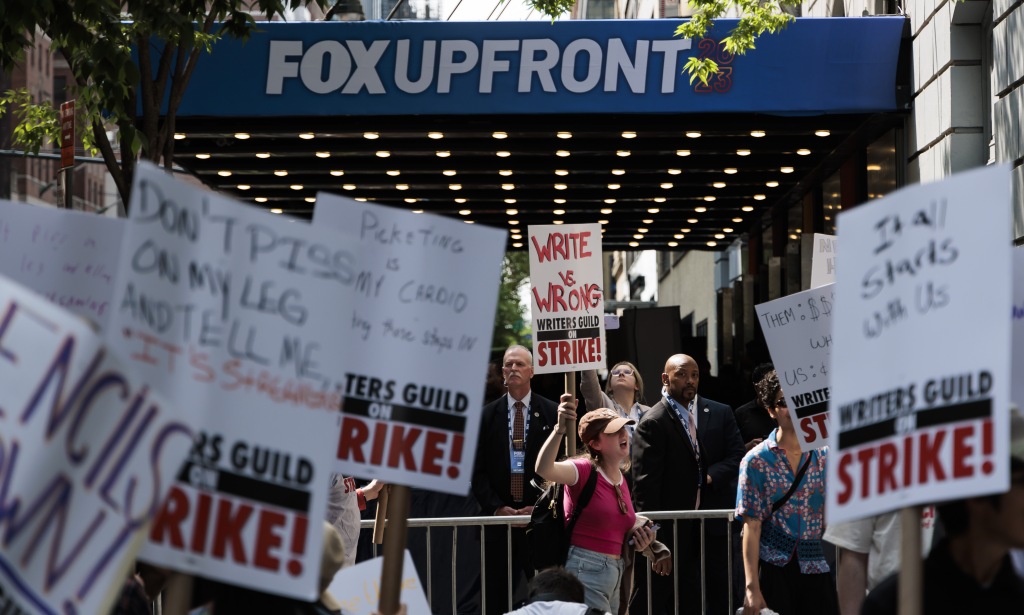 People participate in a Writers Guild of America picket line outside of a Fox Upfront presentation on May 15, 2023.