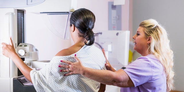 Woman getting mammogram