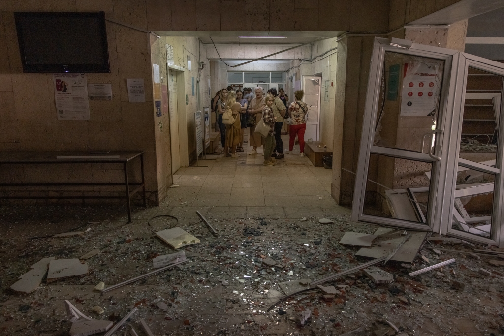 People stand inside a damaged building during a Russian missile attack on June 1, 2023 in Kyiv, Ukraine. 