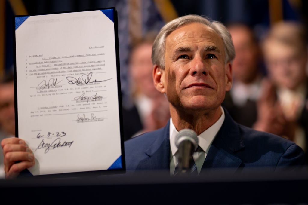 Texas Gov. Greg Abbott displays a bill he signed at a news conference at the state Capitol on June 8, 2023 in Austin, Texas. 