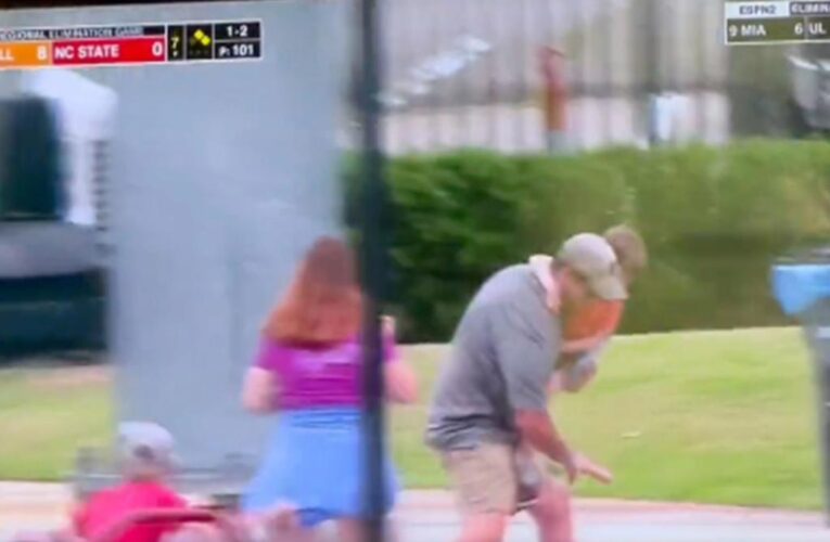 Dad holding small child trips and falls while pursuing fly ball: video