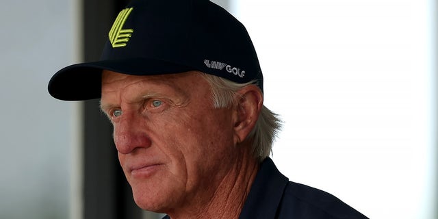 Greg Norman looks on