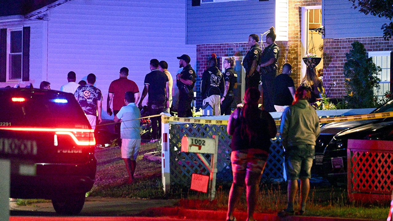 People standing around a house