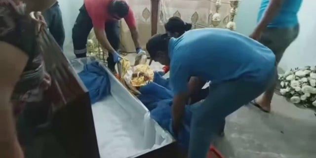 Ecuadorian woman lifted out of coffin after mourners discover she is alive