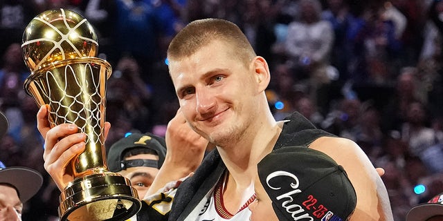 Nikola Jokic smiles with trophy