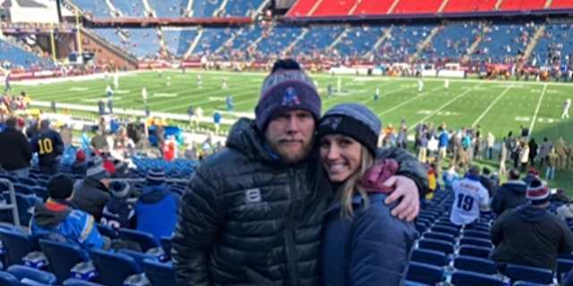 Eric and Kouri Richins at a football game