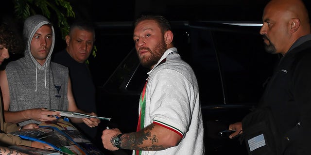 Conor McGregor signs autographs